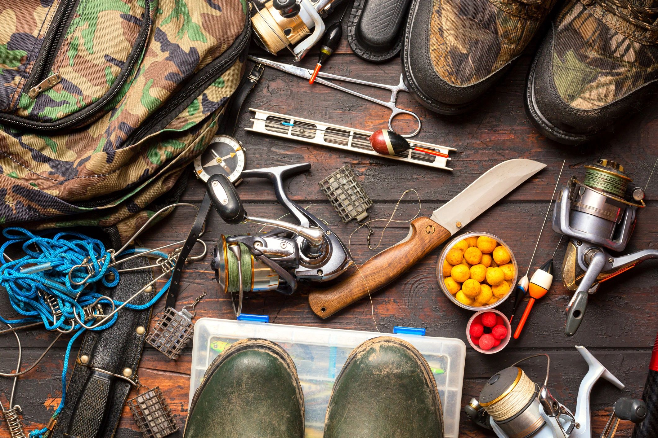 A table with fishing gear and boots on it