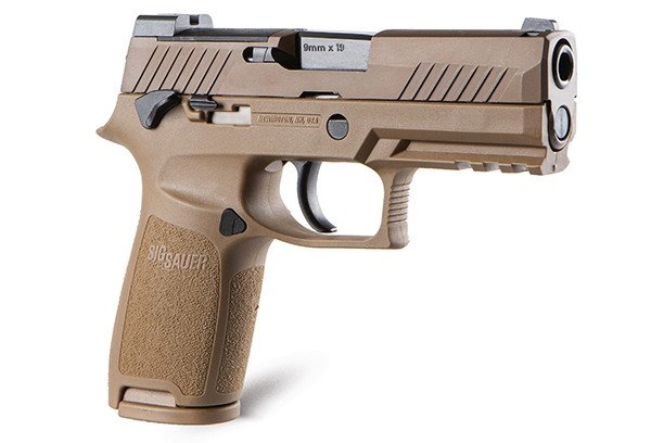 Tan 9mm handgun on a white background.