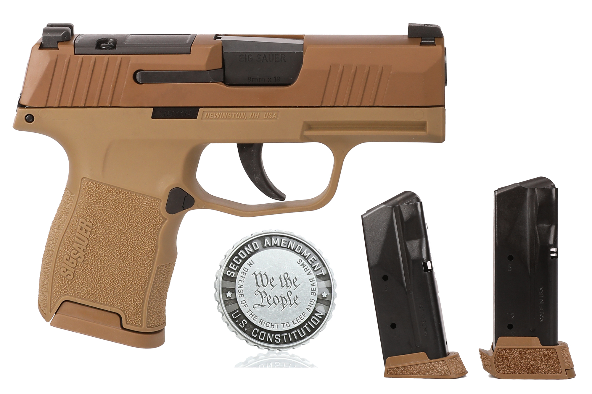 Handgun with magazines and Second Amendment coin.