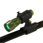 Green tactical flashlight mounted on rail.