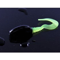 Black and green fishing lure on surface.