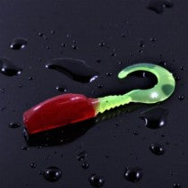 Colorful fishing lure on a wet surface.