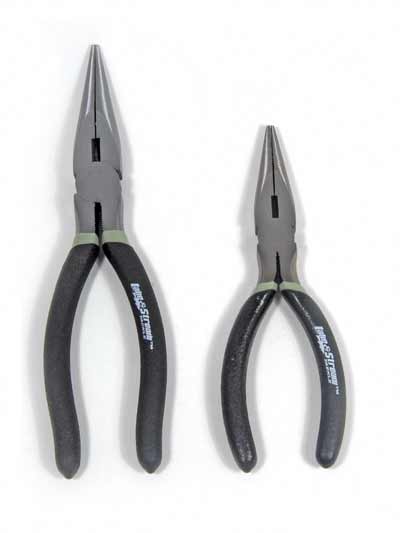 Pliers of different sizes on white background.